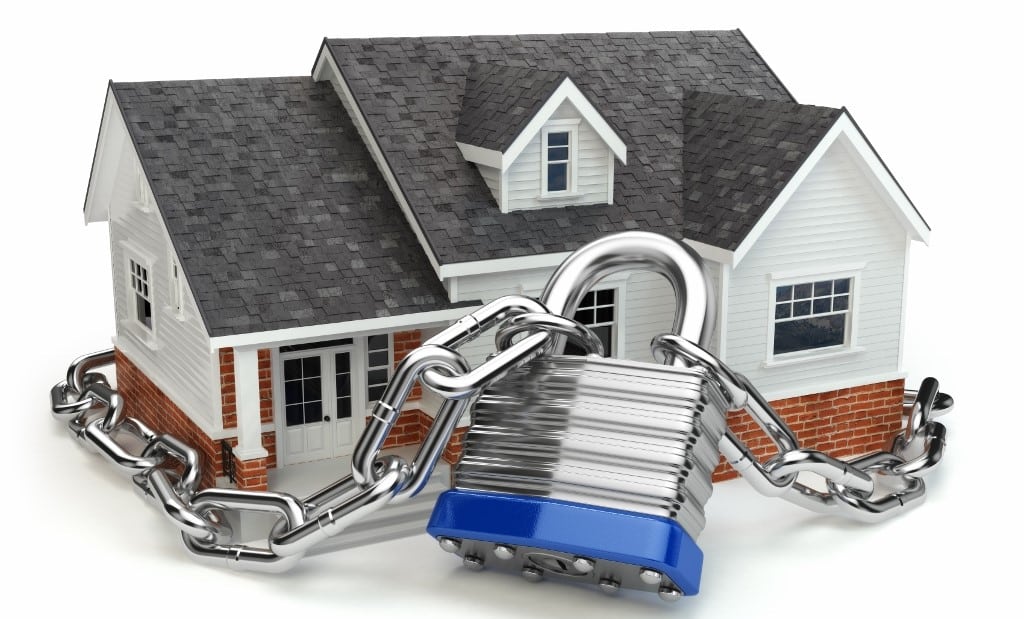 Home security concept. House with lock and chain