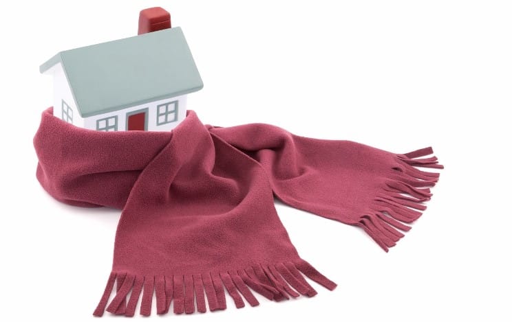 House wrapped in a scarf isolated on white