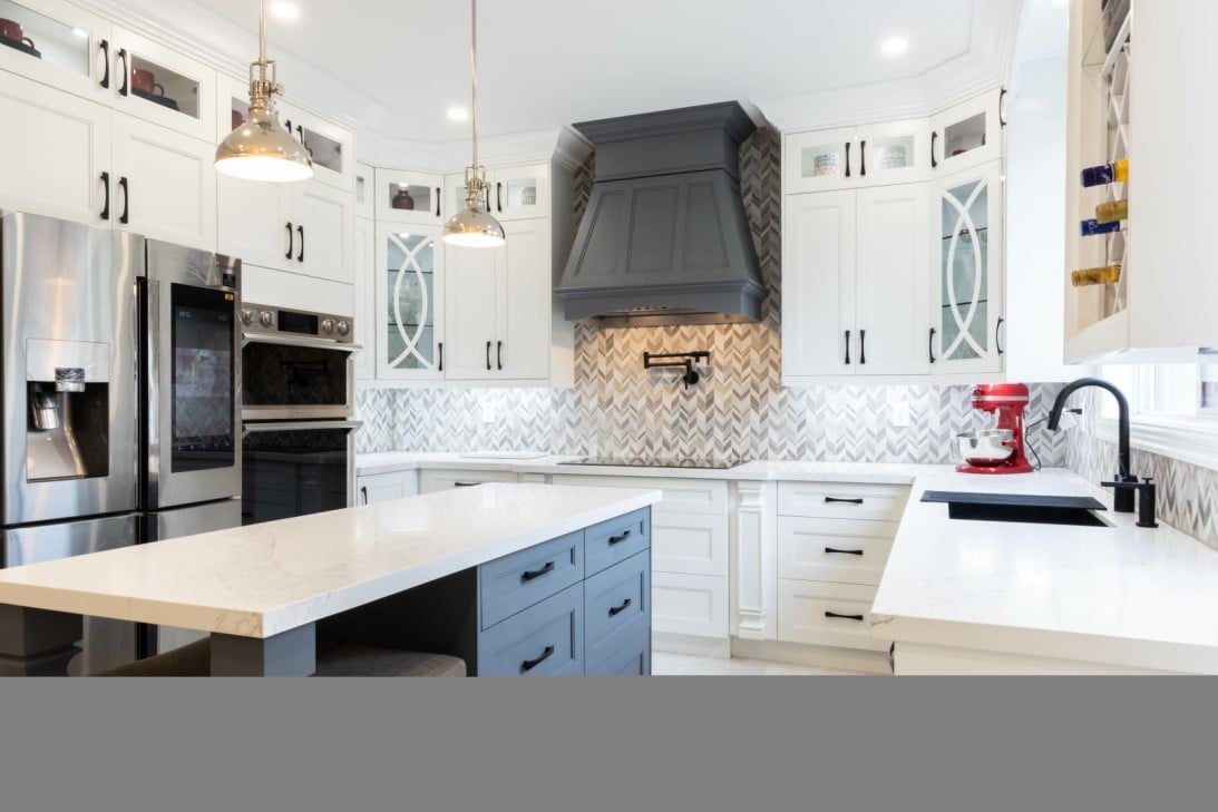 modern kitchen design with chevron backsplash and white cabinetry.