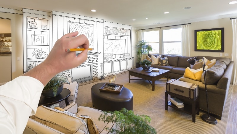Male Hand Drawing Entertainment Center Over Photo of Home Interior