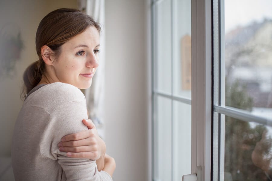 freezing-woman-looking-from-a-window